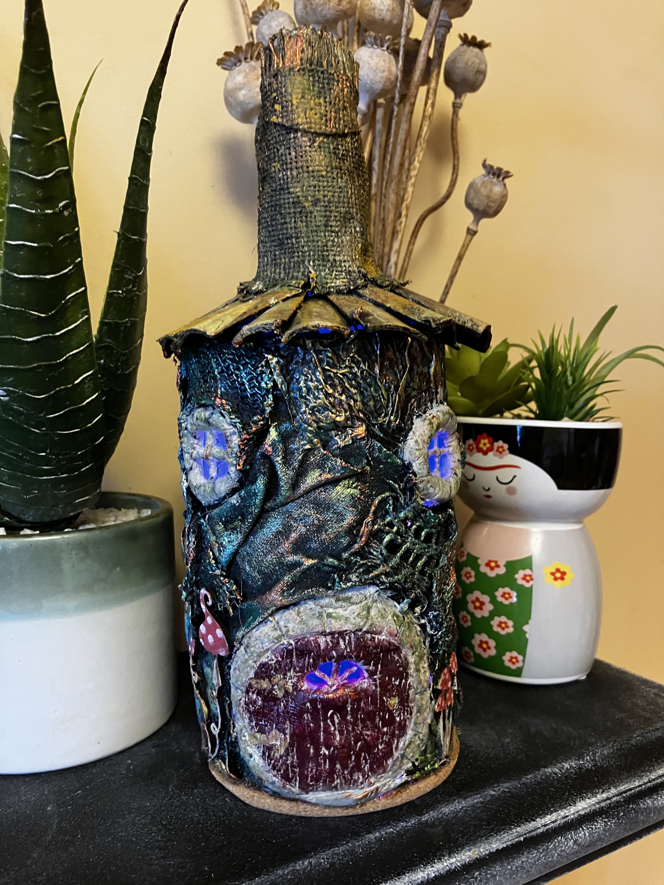 Eco-Friendly Fairy House Bottle Lamp - Handcrafted Whimsical Decor with Recycled Glass  and Fabrics and Glowing Blue windows